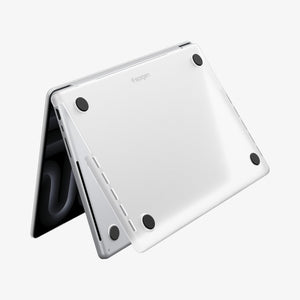 Spigen MacBook Pro 14-inch Air Skin in Frost Clear showing the bottom exterior with four rubber feet and the Spigen logo visible on a white background